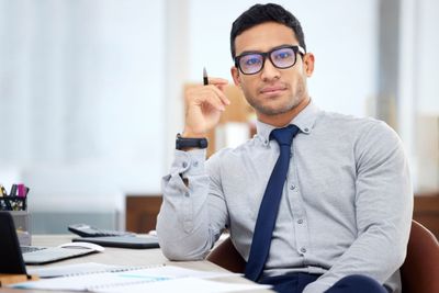 young-mixed-race-businessman-going-through-a-repor-2024-09-05-23-29-02-utc.jpg